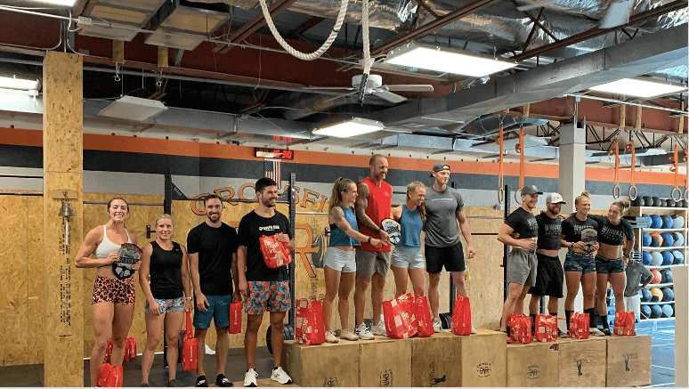 CrossFit DNR Team Muscle & Hustle taking the 3rd place podium spot in the RX division at Barbells and Badges fundraiser Comp Best gym in Fort Collins